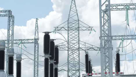 many high voltage electrical insulators in power substation against blue sky background