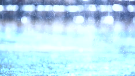 slow motion rain falling on ground, close up view