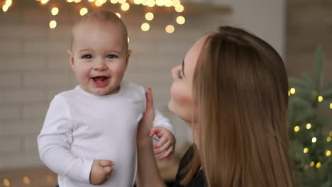 mother and baby slow motion. happy family. mom with her child smiling and laughing at home.