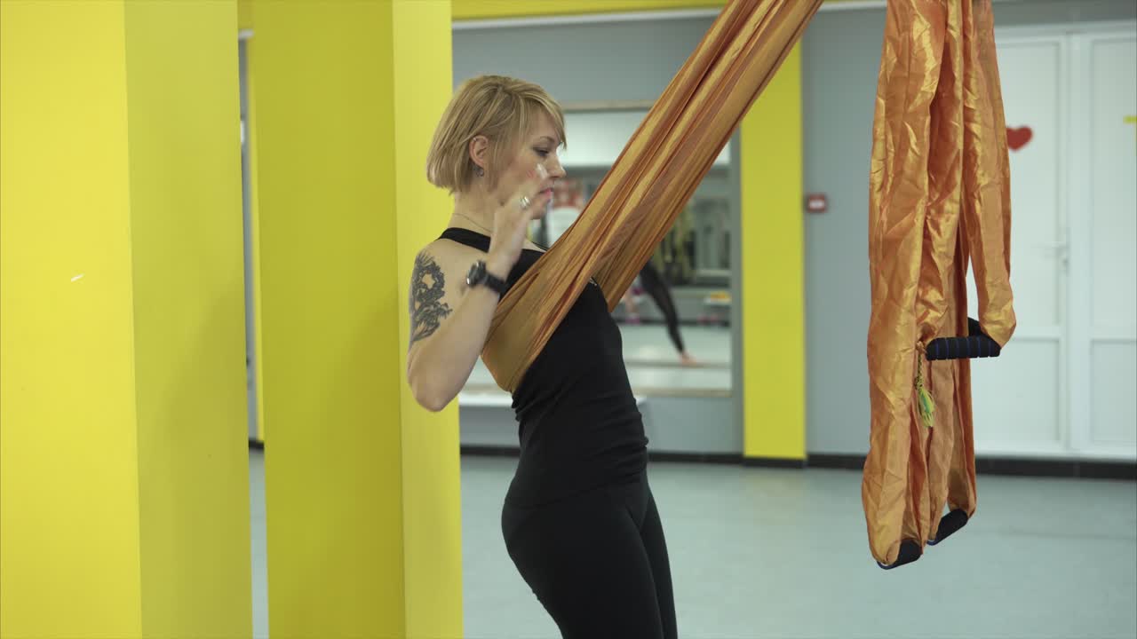 Woman Doing Aerial Yoga in a Gym