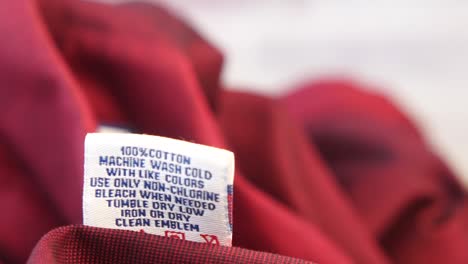 close up of care label on a red garment