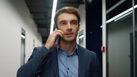 Smiling-professional-talking-phone-in-office-closeup.-Happy-executive-celebrate