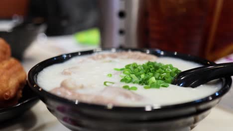 bowl of chinese congee with pork