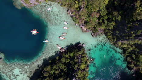 drone view of philippines, coron island’s untouched coastline, surrounded by clear ocean waters. aerial view of boats vertical video.