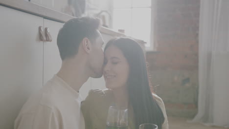 couple enjoying wine in a kitchen