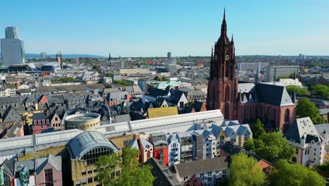 4k aerial drone video of the clock tower of the historic kaiserdom st. bartholomäus church in downtown frankfurt, germany