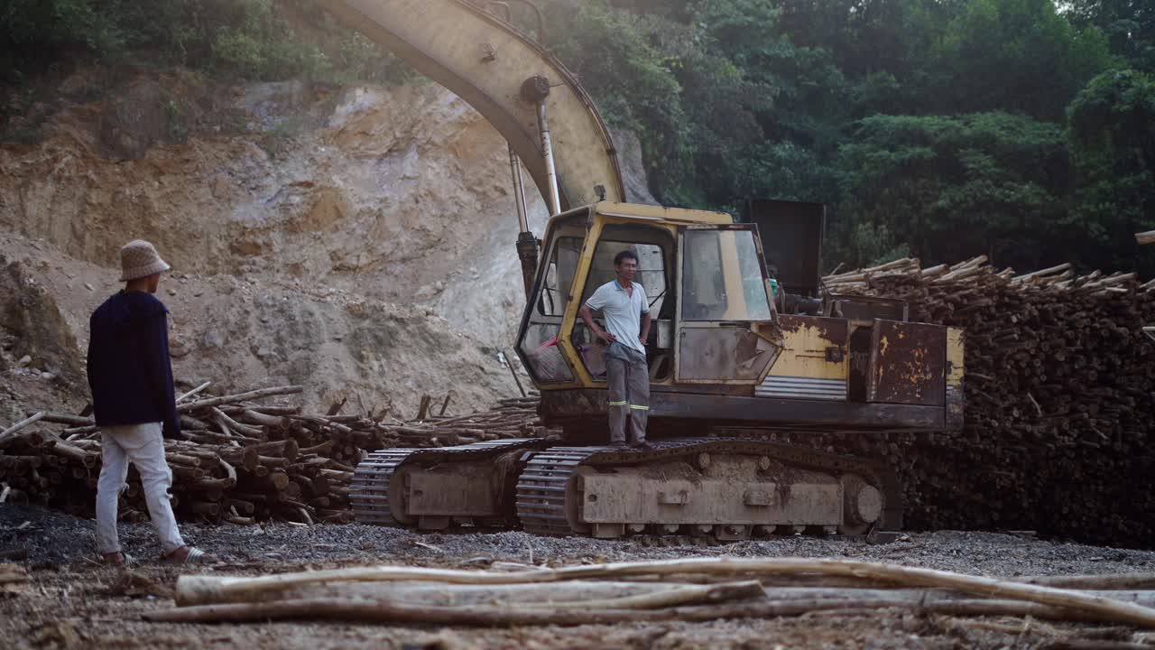 Excavator and Workers at a Logging Site
