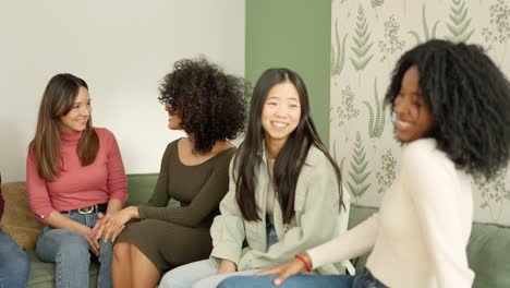 Multi-ethnic friends chatting and smiling at home
