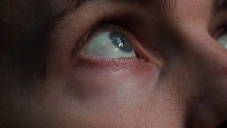 Static-close-up-shot-of-the-blue-eyes-of-a-traveler-in-the-jungle-looking-out-for-hazards-and-taking-in-the-beauty-of-the-island-on-an-adventurous-journey-through-norfolk-island-in-australia