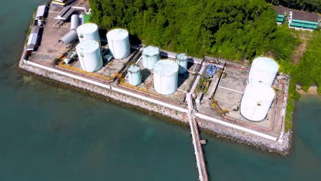 aerial drone top view of tank farm oil and gas terminal with lots of fuel petroleum chemical natural gas storage tank and petrochemical in the harbor. power and energy industrial tank storage