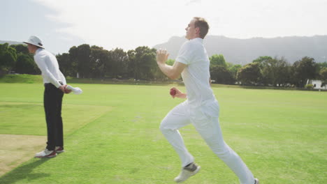 side view of cricket payer throwing a ball