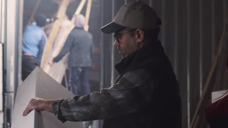 construction worker inspecting building materials