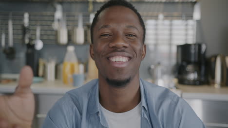 man smiling at camera in kitchen