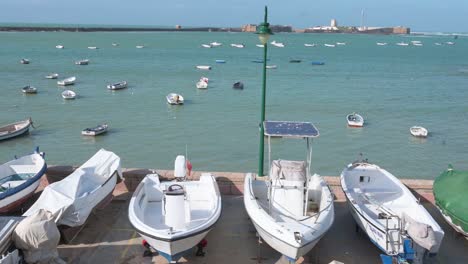 boats are seen put aside on the dock at the seafront promenade in cadiz, spain