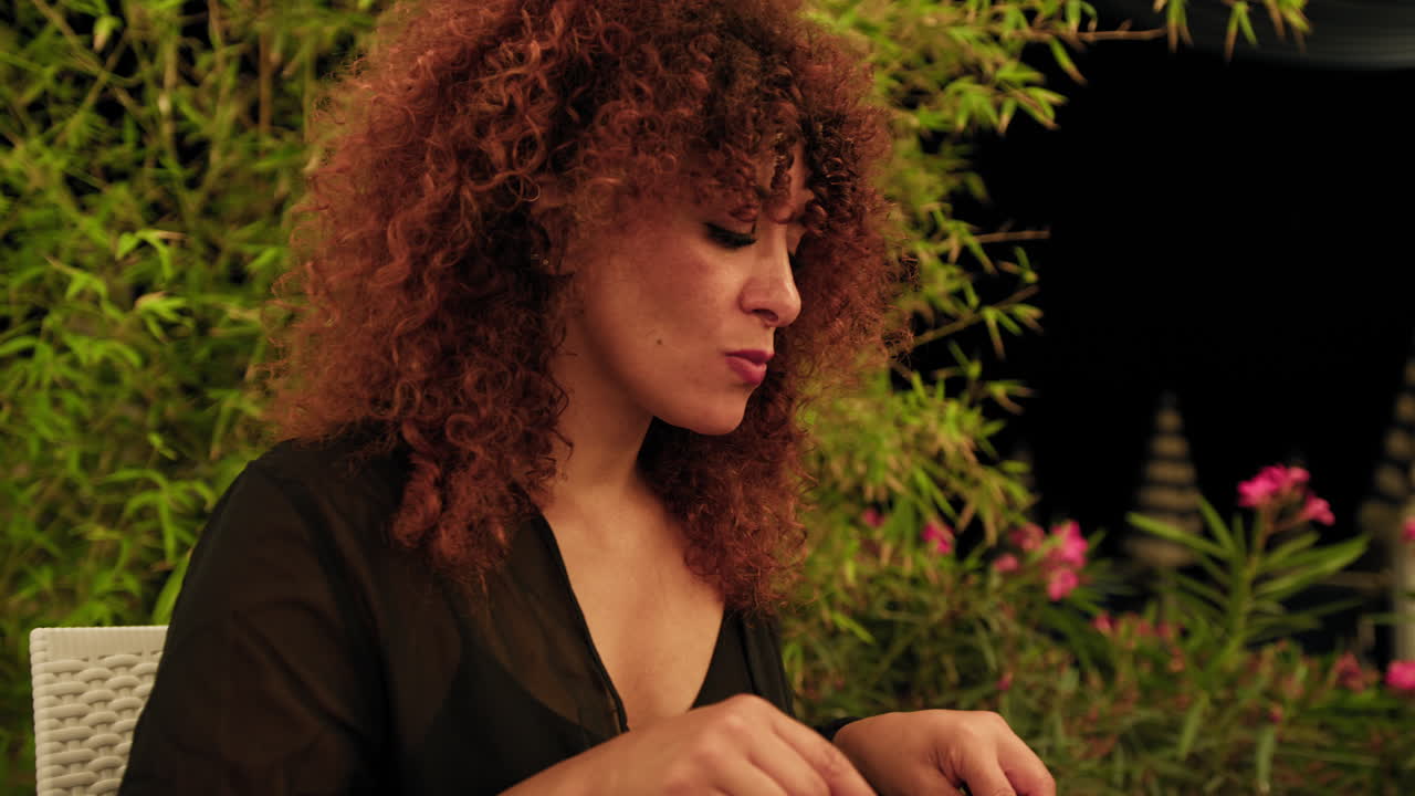 During Dinner At The Beach Resort A Woman Focused On The Gourmet Dish