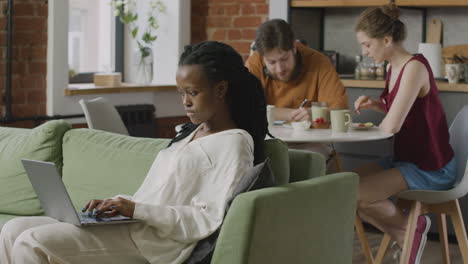 Girl-Sitting-On-Sofa-And-Working-On-Laptop-Computer