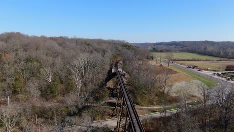 aerial shot pushing towards the end of the pope lick railroad trestle in louisville kentucky on a sunny afternoon