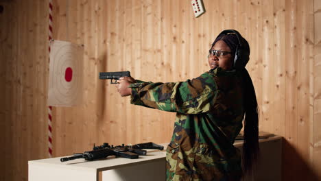 cheerful person in shooting gallery using safety gear to prevent damage