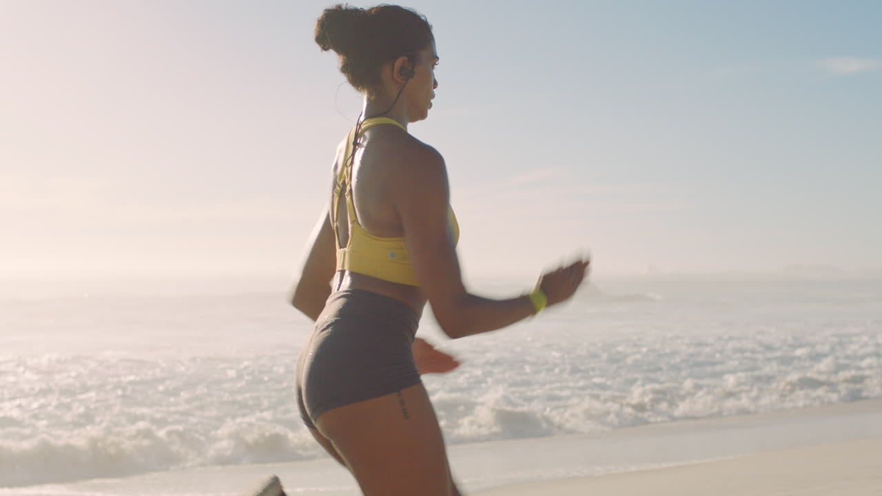 Fit, active and sporty jogger running at sunset