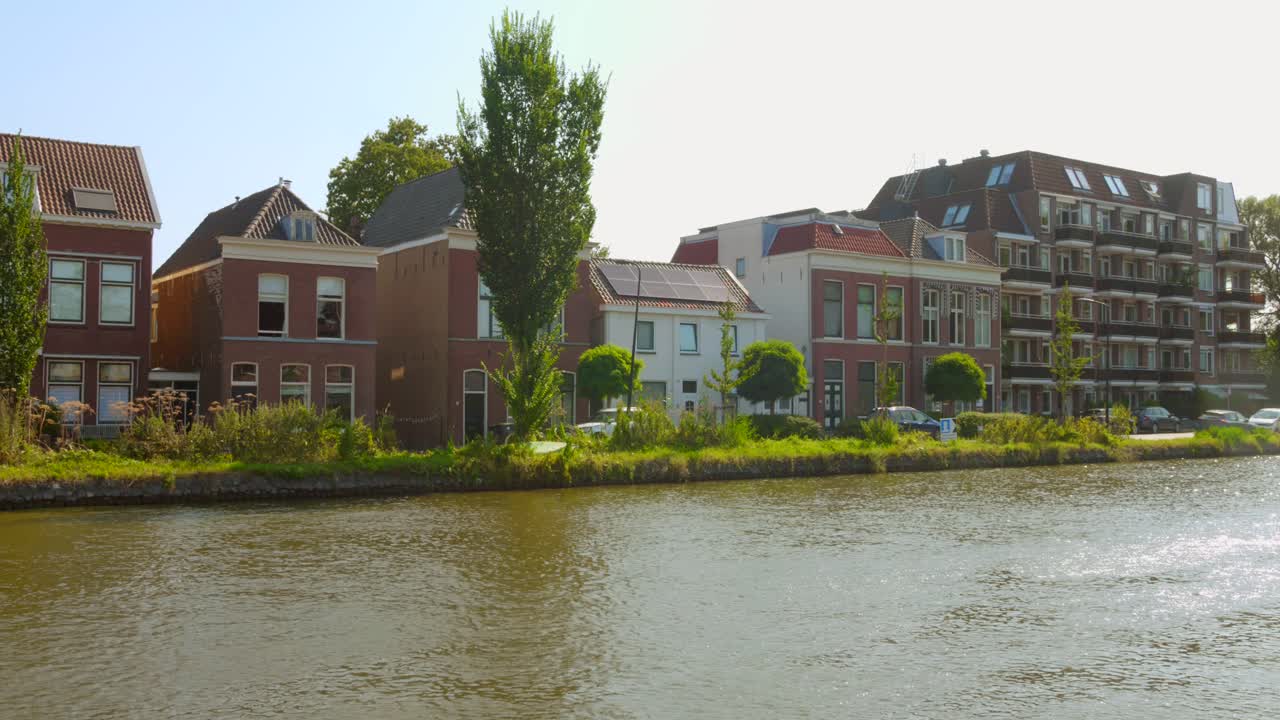 Canal Buildings In The City And Municipality Of Delft In South Holland, Netherlands. Wide Shot