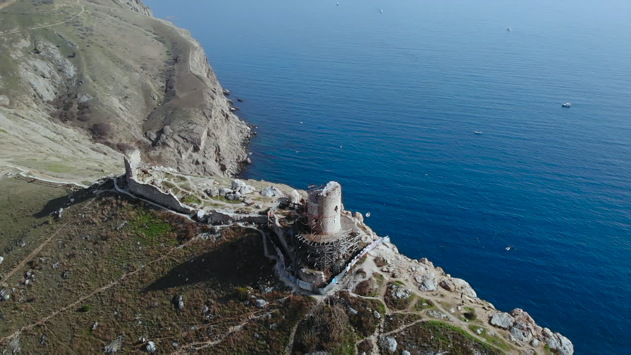 Aerial view of ancient ruins on a cliff overlooking the sea