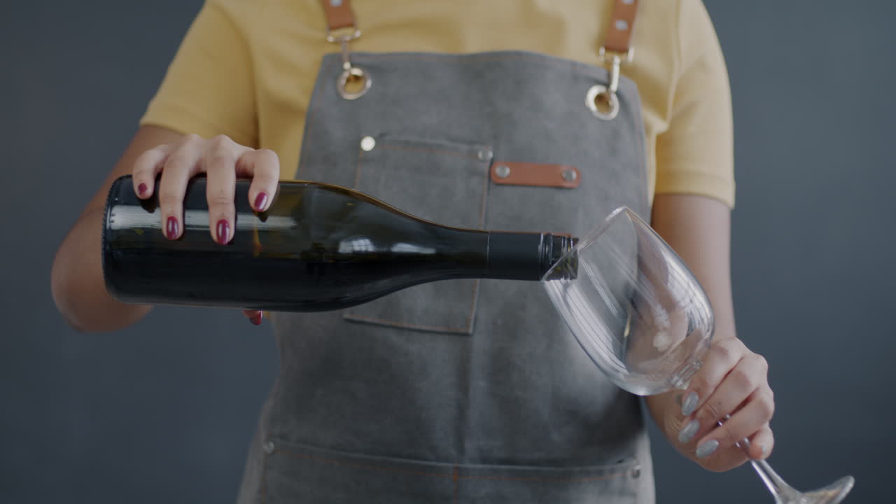 Waitress pouring red wine