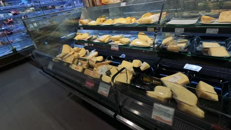 variety of cheeses displayed in a market