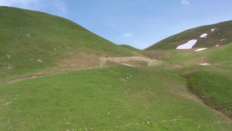 participants of fell running on lush mountain pass in the alps of little saint bernard in france