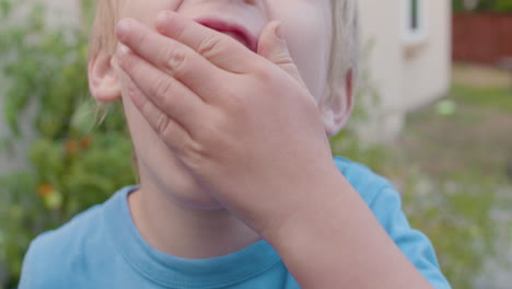 cute little boy stuffing grapes into his mouth