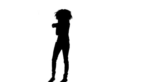 silhouette woman is dancing and singing