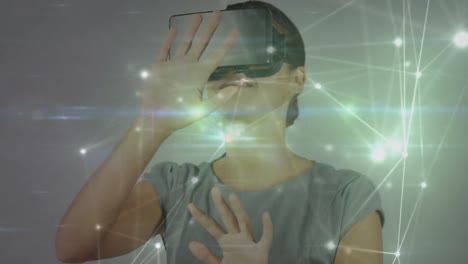 animation of network of connections over businesswoman wearing vr headsets