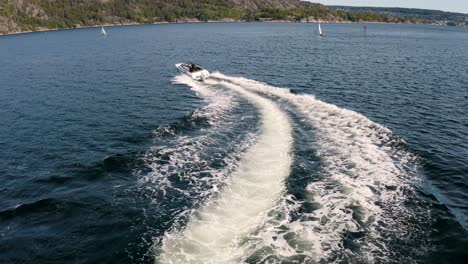 boat drives away from dock and turns left out of frame