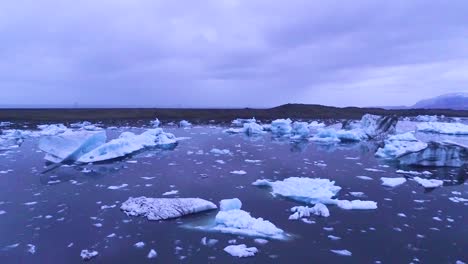 drone aerial over icebergs in a glacial bay suggest global warming in the arctic at jokulsarlon glacier lagoon iceland night 3