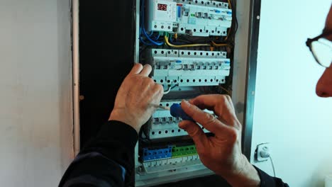 electricians hands working on current  electric in control panel. electrician engineer work