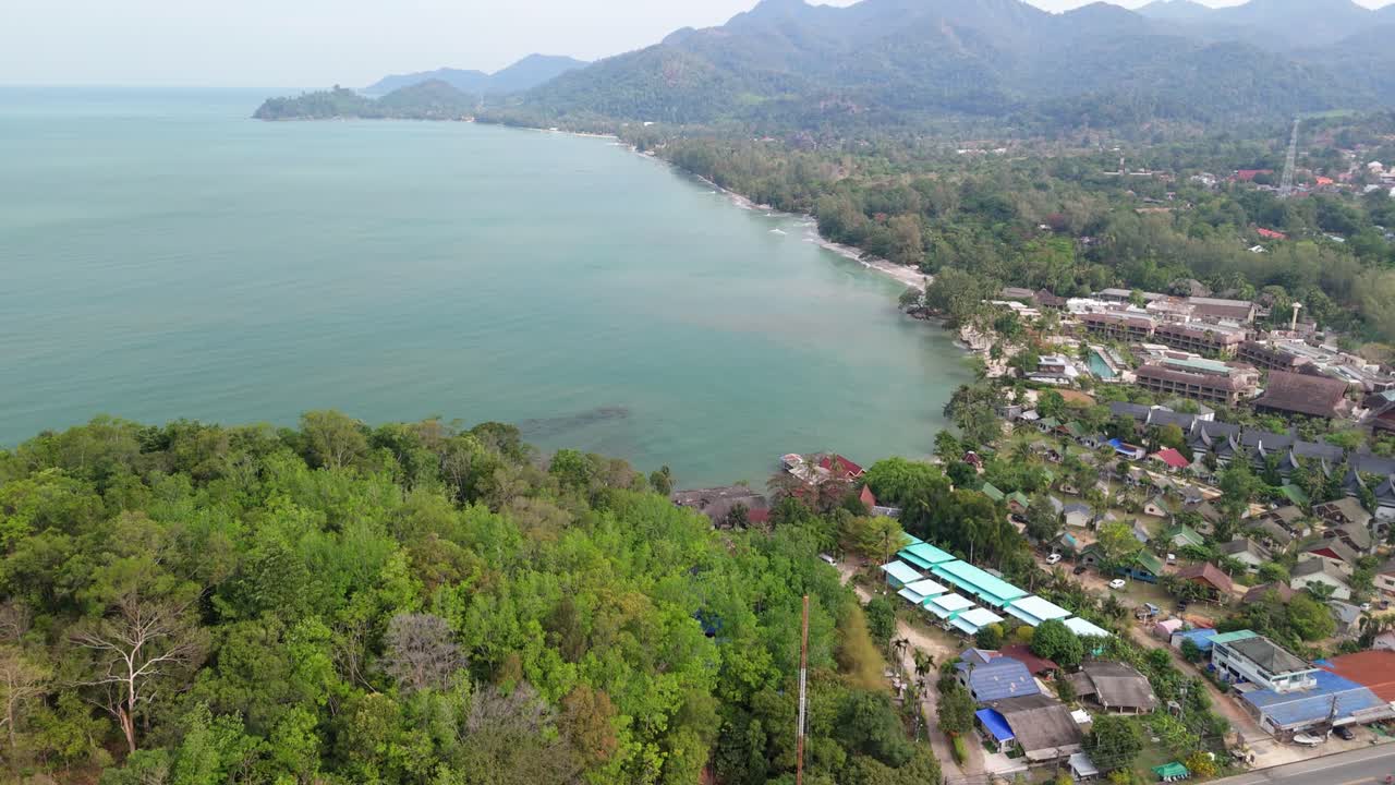 aerial drone footage of Koh Chang island, Klong Prao with main road, shops, mountains and ocean