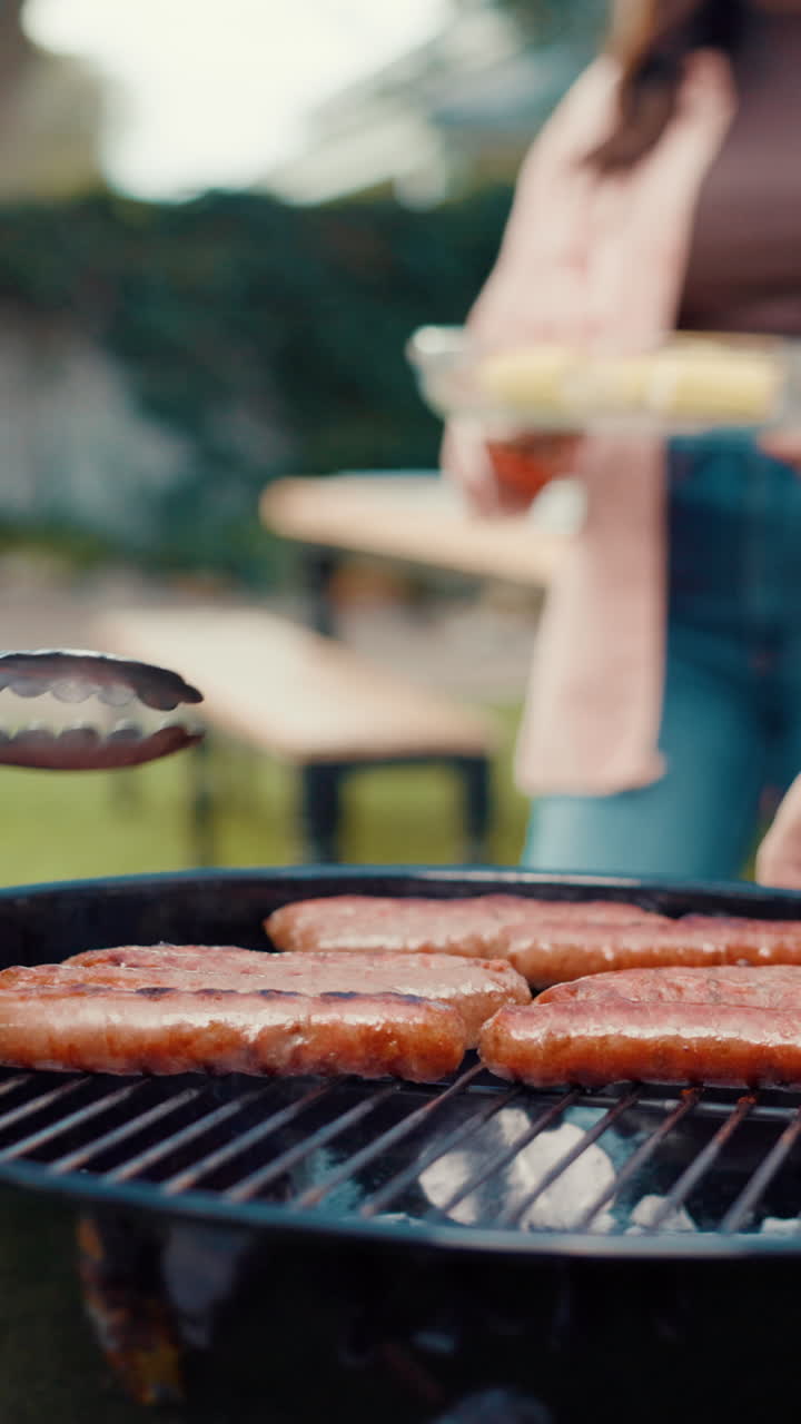 Sausages Cooking on a Barbecue Grill in a Backyard