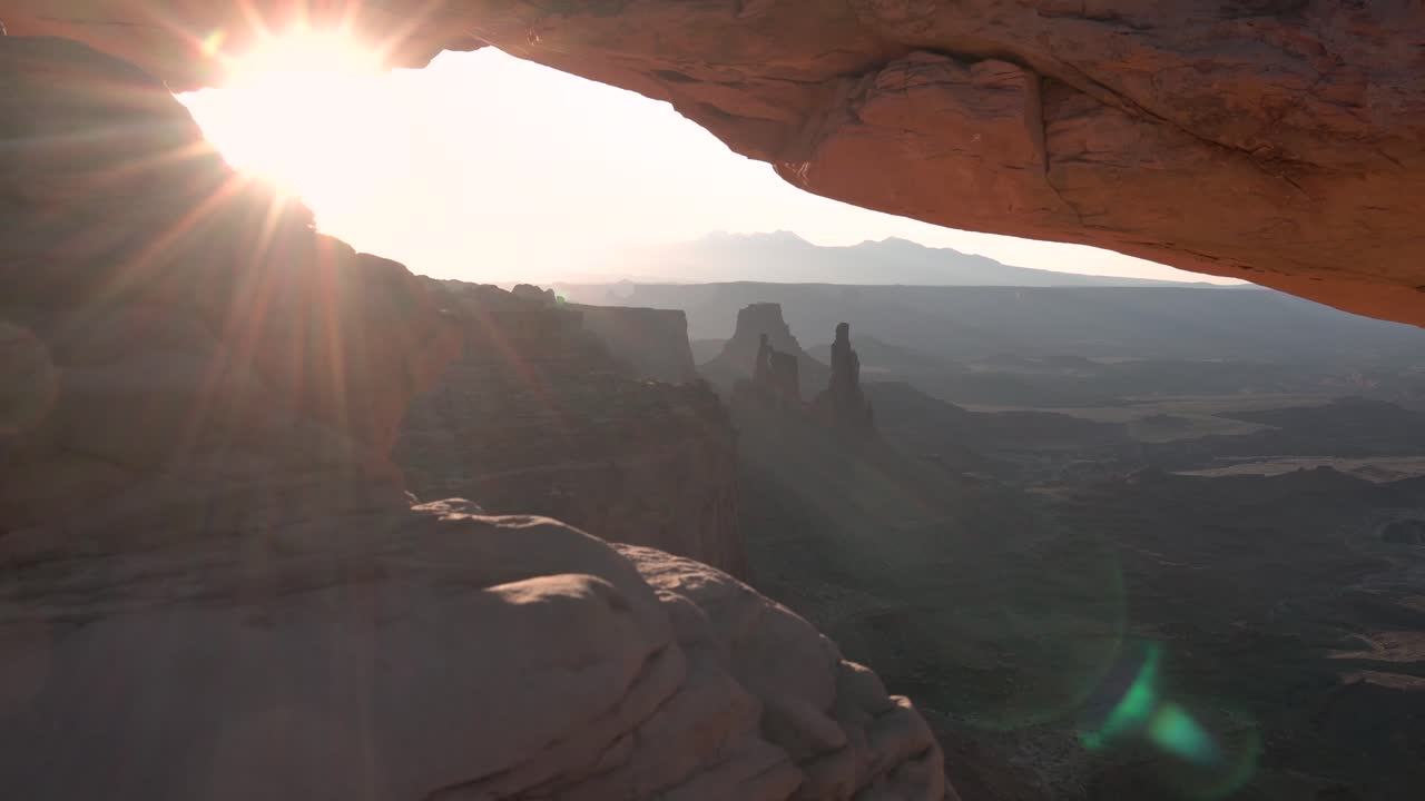 Canyonlands national park washer woman rock formations seen at Mesa arch in Utah, Aerial pedestal reveal shot