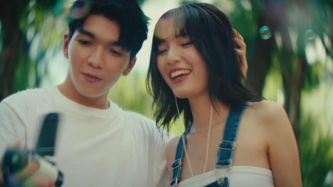 Couple Singing and Making Bubbles in a Park