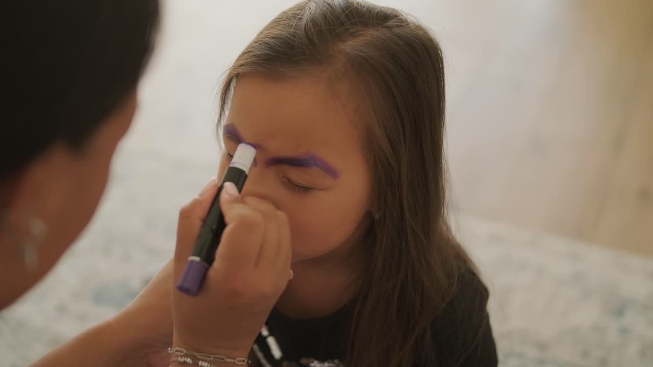 Little Girl Getting Face Painted for Halloween