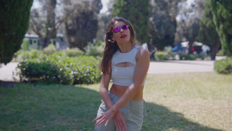 stylish woman dancing in a park