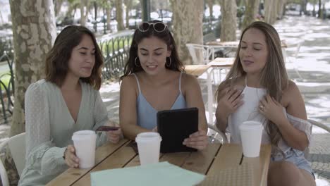 three happy women ordering product online and paying