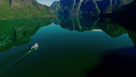 cruise ship in an inlet near flam, norway - landscape reflecting off the water