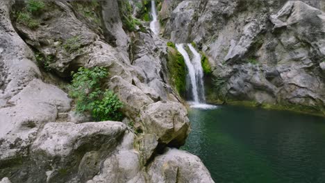 gubavica waterfall flows on craggy steep mountains on the cetina river in dalmatia, croatia