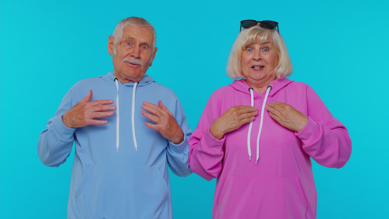 Senior grandfather grandmother feeling very proud pointing themselves, overjoyed by success win