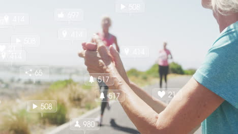 animation of social media notifications, over woman clapping women running by beach