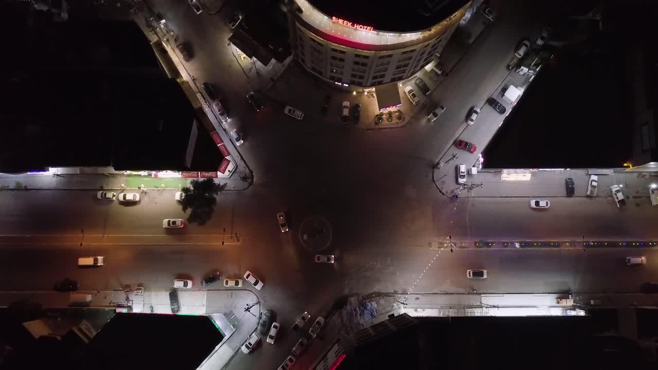Aerial Shot to Al-Shurta neighborhood roundabout in Erbil ٫Traffic in the street - roundabout - 4K drone top shot night