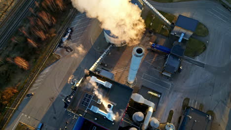 aerial top down shot over a steam coming out of pipes in a thermal power plant