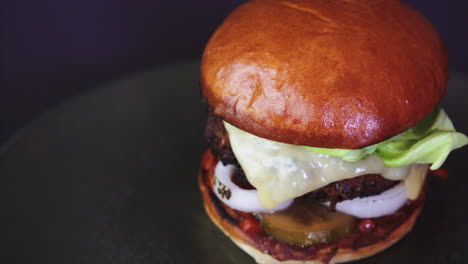 Fresh-smoky-appetizing-cheeseburger-rotating-in-4k