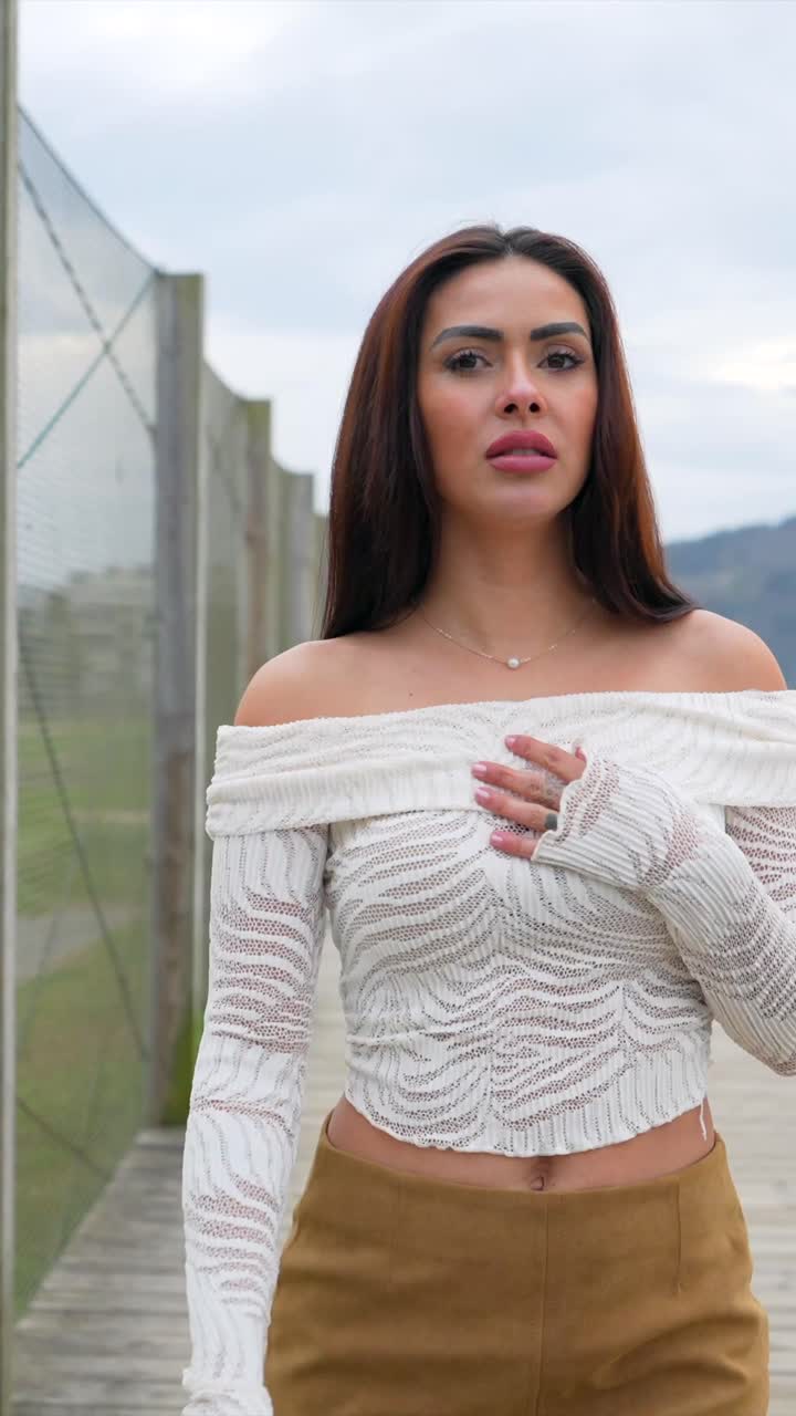 Beautiful woman in white dress posing outdoors