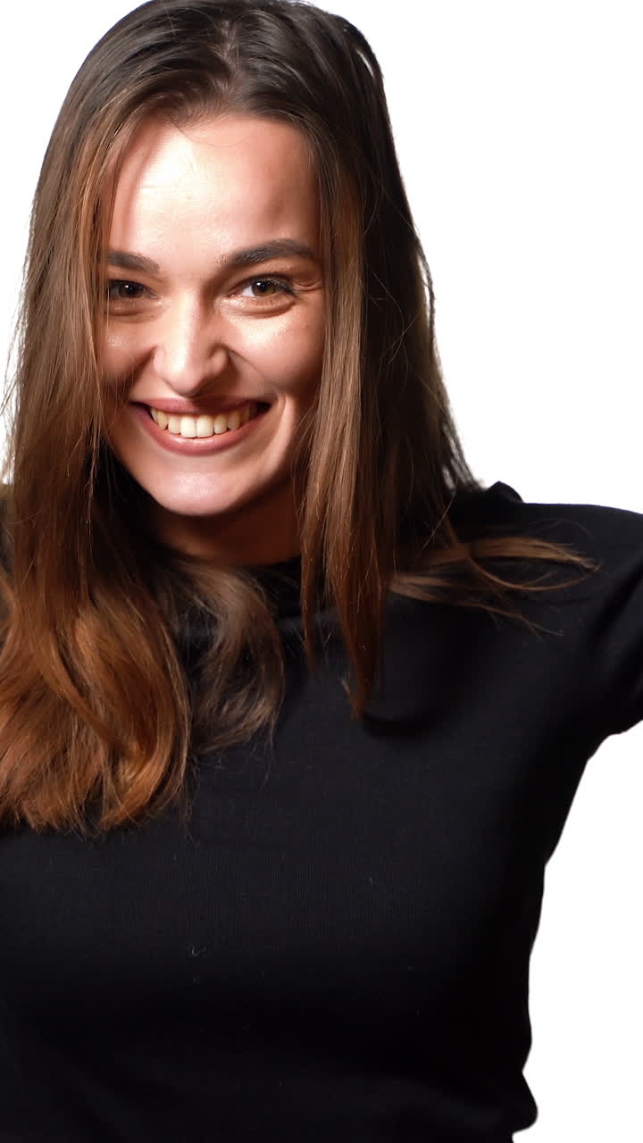 Happy woman with shopping bags. Young woman with shopping on white background. Vertical video